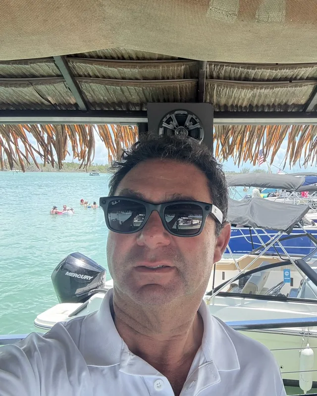 Captain Evan, a selfie under the thatched roof of the tiki boat